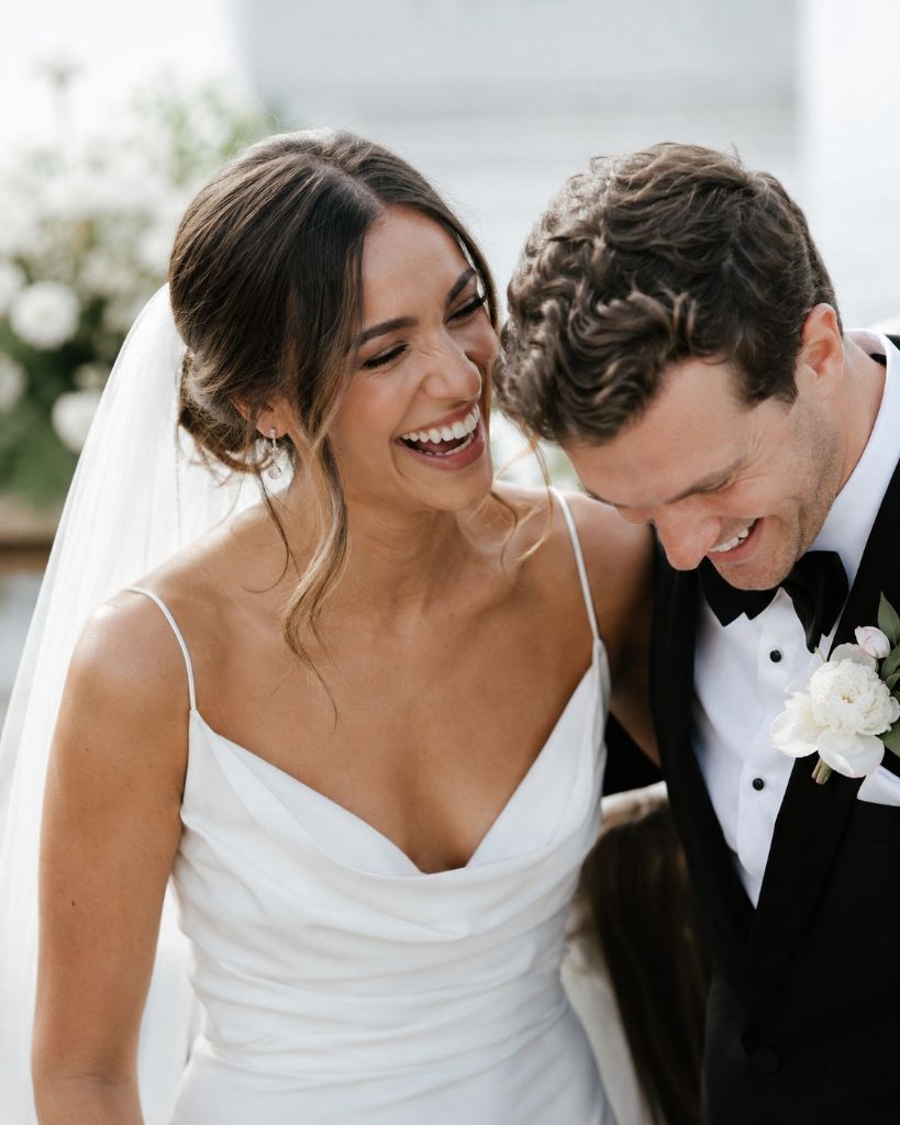 Wedding guests using their phones to capture the bride and groom's first dance
